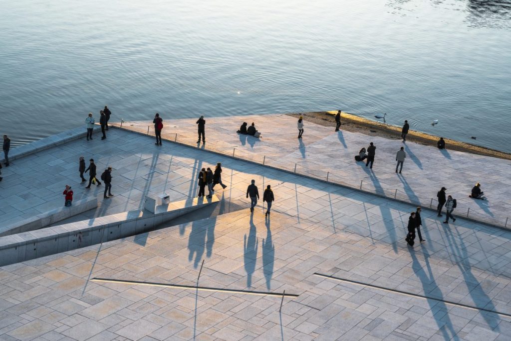 People walking around harbour promenade